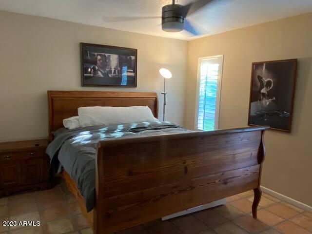 11222 North Miller Road Scottsdale, AZ 85260 - Photo 23 of 32 a bed sitting in a bedroom next to a window
