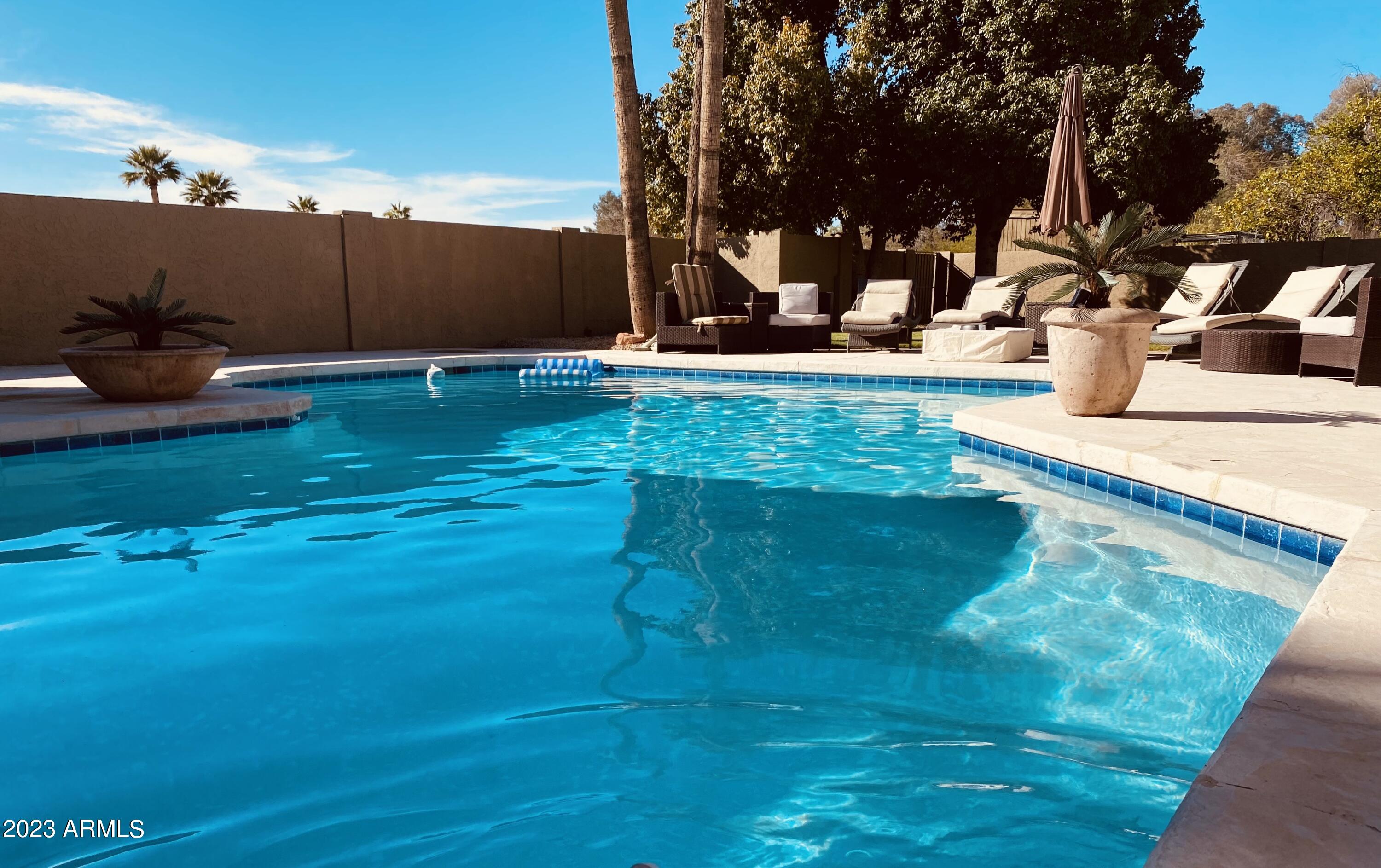 11222 North Miller Road Scottsdale, AZ 85260 - Photo 5 of 32 a backyard of a house with table and chairs