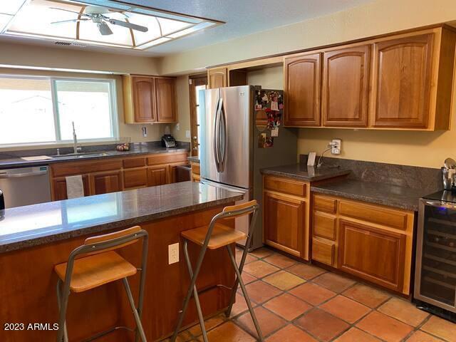 11222 North Miller Road Scottsdale, AZ 85260 - Photo 9 of 32 a kitchen with stainless steel appliances granite countertop a sink and a refrigerator