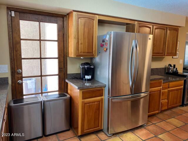 11222 North Miller Road Scottsdale, AZ 85260 - Photo 10 of 32 a metallic refrigerator freezer sitting inside of a kitchen