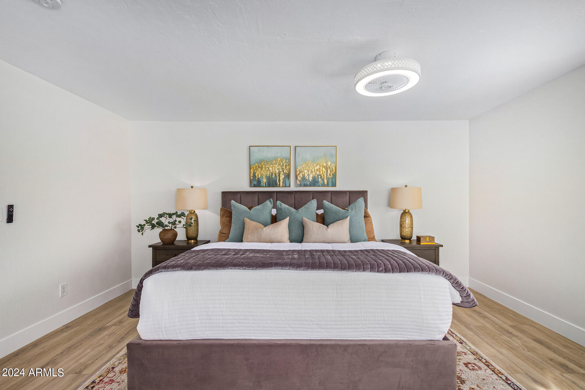 5712 North Scottsdale Road Paradise Valley, AZ 85253 - Photo 19 of 34 a bedroom with a bed and painting on the wall