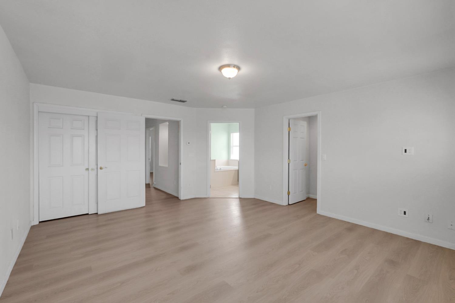 1412 Red Ribbons Lane Manteca, CA 95337 - Photo 24 of 32 a view of an empty room with wooden floor and closet