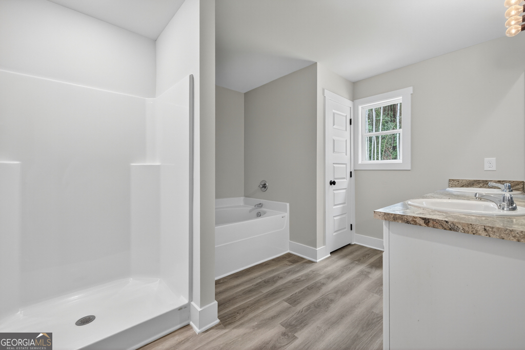 474 Oil Mill Road, Unit 11 Martin, GA 30557 - Photo 23 of 30 a bathroom with a granite countertop sink a bathtub and shower