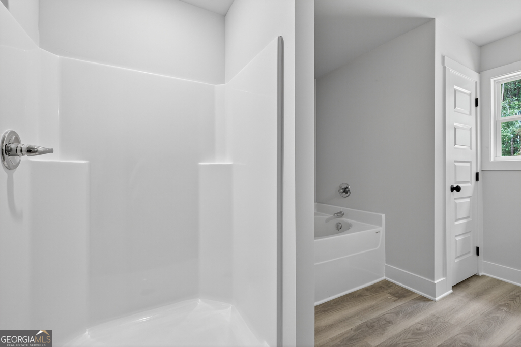 474 Oil Mill Road, Unit 11 Martin, GA 30557 - Photo 25 of 30 a bathroom with a bathtub a toilet and a shower