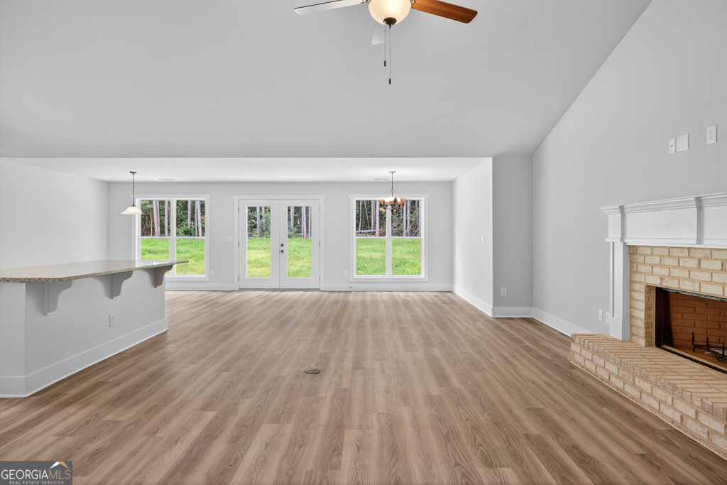 474 Oil Mill Road, Unit 11 Martin, GA 30557 - Photo 4 of 30 a view of an empty room with wooden floor and a fireplace