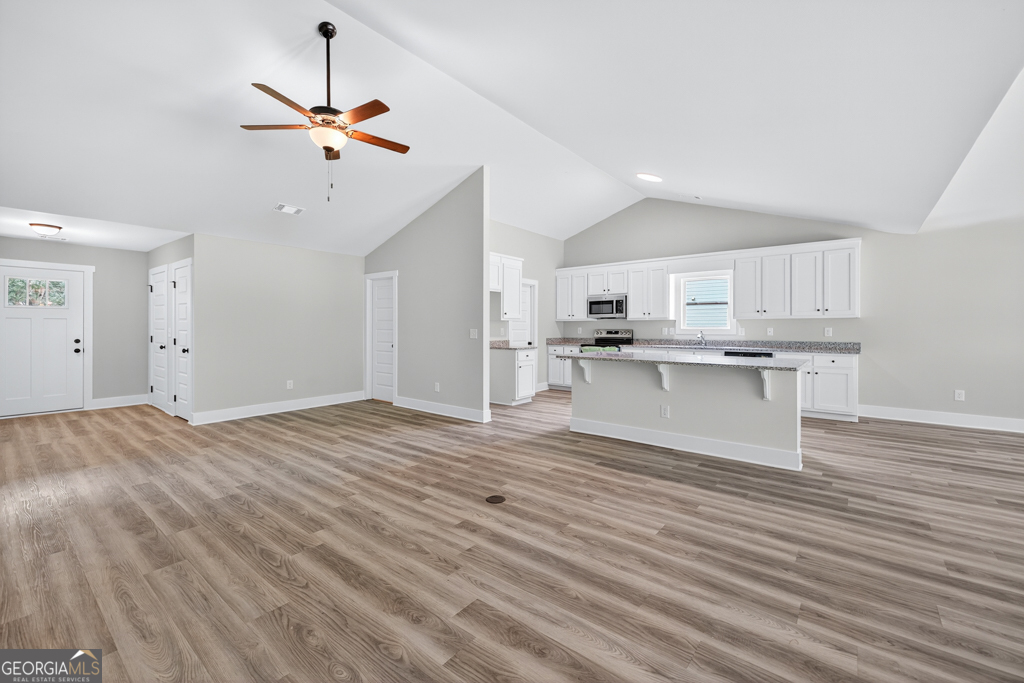 474 Oil Mill Road, Unit 11 Martin, GA 30557 - Photo 7 of 30 a view of a kitchen with a stove cabinets and wooden floor