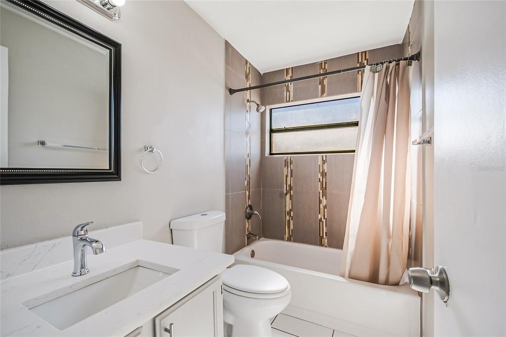 117 Pansy Court Kissimmee, FL 34743 - Photo 11 of 40 a bathroom with a sink a toilet and shower