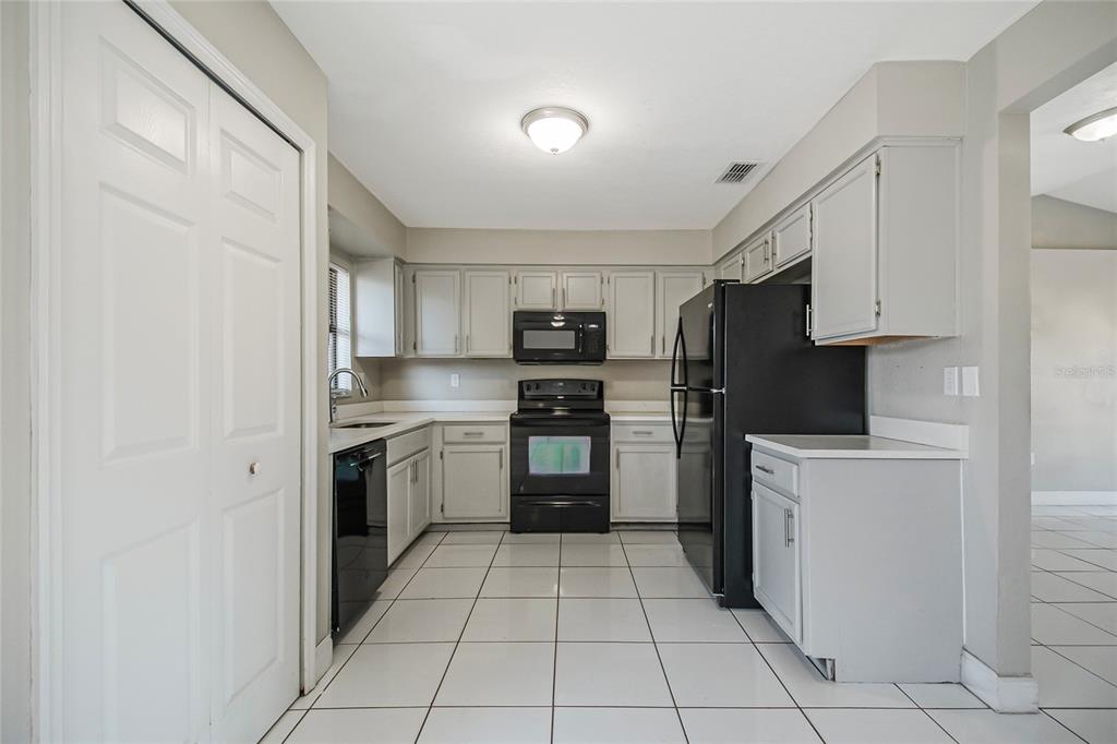 117 Pansy Court Kissimmee, FL 34743 - Photo 23 of 40 a kitchen with stainless steel appliances granite countertop a refrigerator and a stove top oven