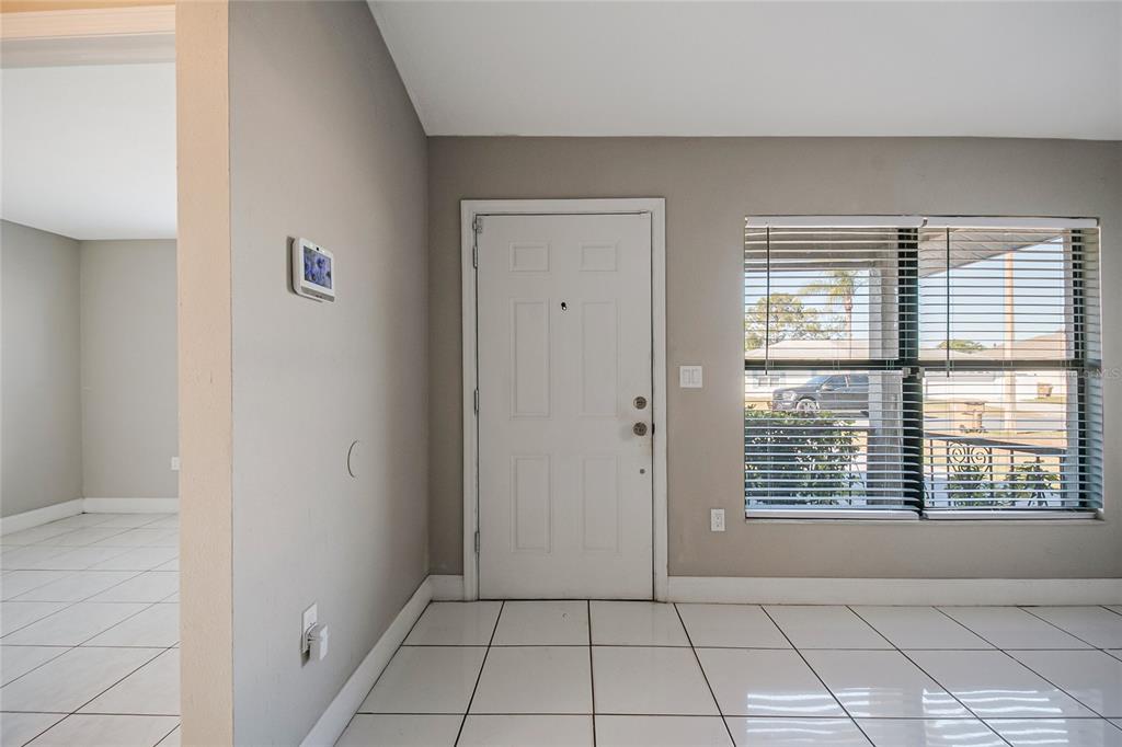 117 Pansy Court Kissimmee, FL 34743 - Photo 3 of 40 a view of an empty room with windows