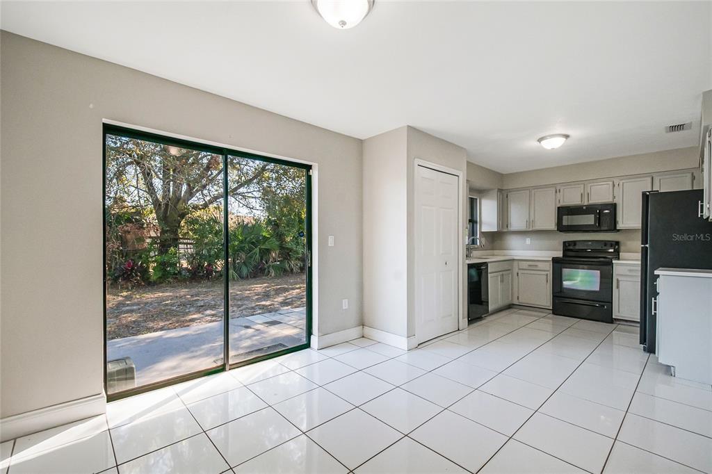 117 Pansy Court Kissimmee, FL 34743 - Photo 31 of 40 a kitchen with stainless steel appliances a refrigerator sink and cabinets