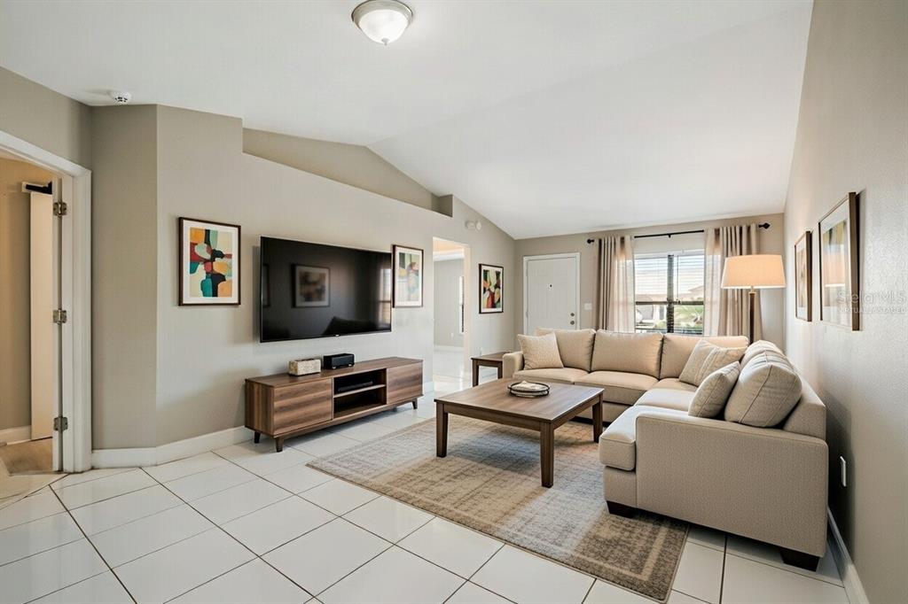 117 Pansy Court Kissimmee, FL 34743 - Photo 4 of 40 a living room with furniture and a flat screen tv