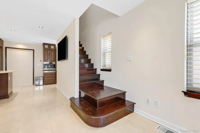a bedroom with a large bed and a large window