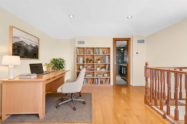 a view of hallway with wooden floor