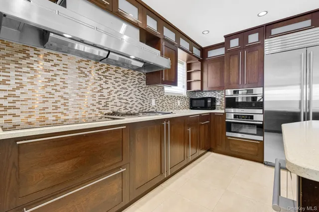 a kitchen with stainless steel appliances granite countertop a sink stove and cabinets
