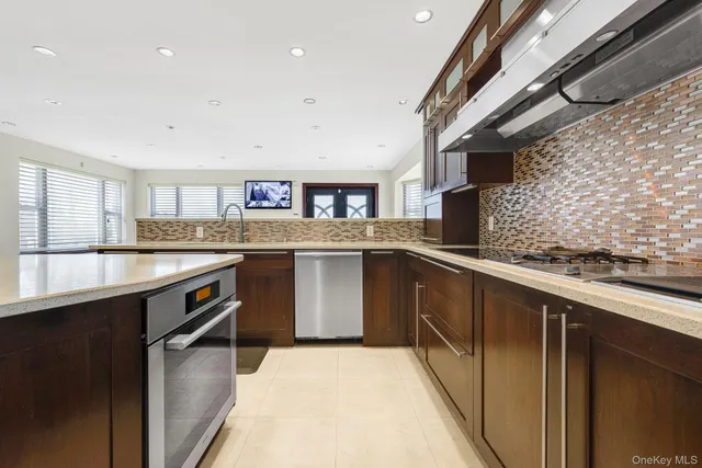 a kitchen with stainless steel appliances granite countertop a sink and stove