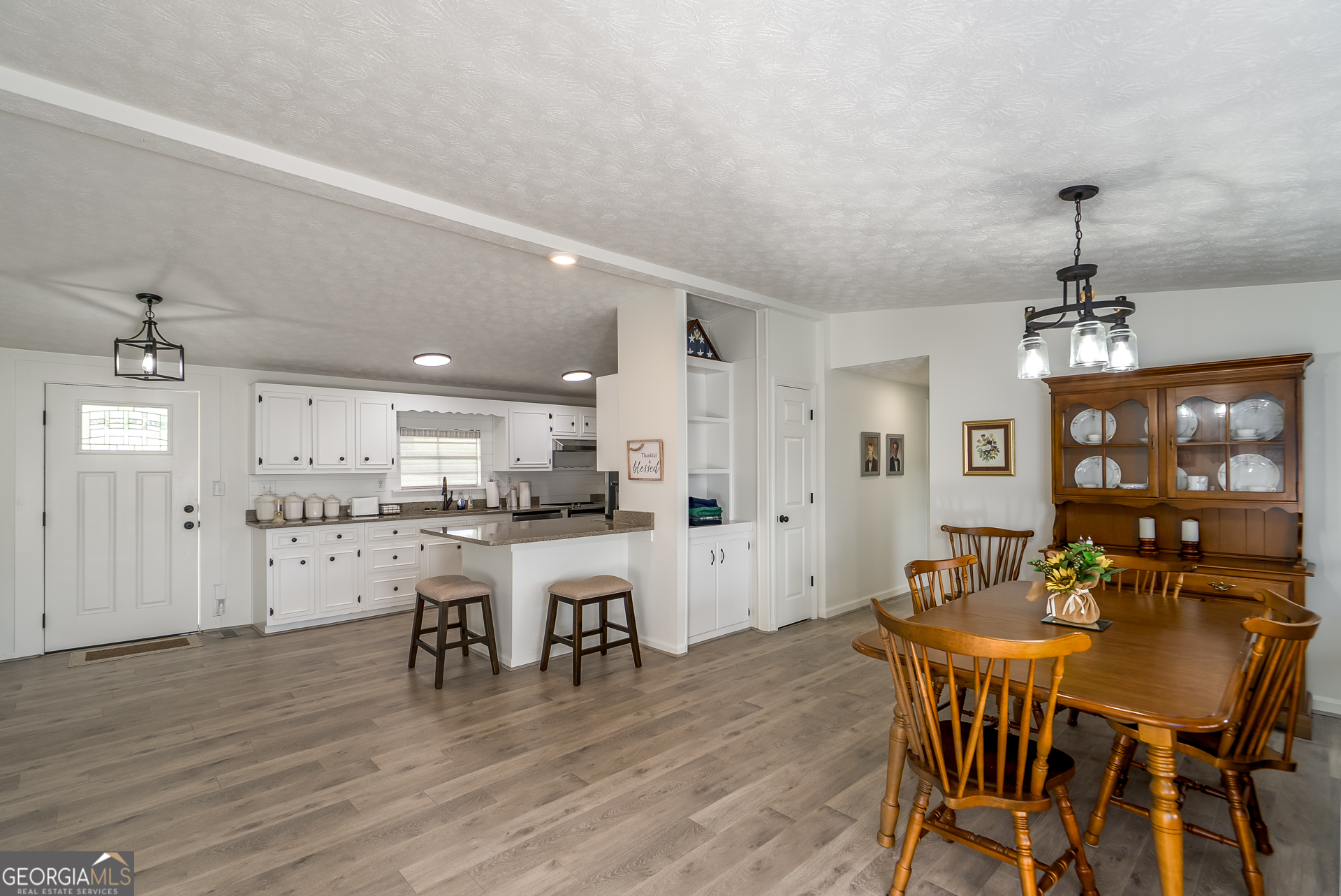1180 Greenbriar Drive Madison, GA 30650 - Photo 13 of 54 a view of a dining room with furniture and wooden floor
