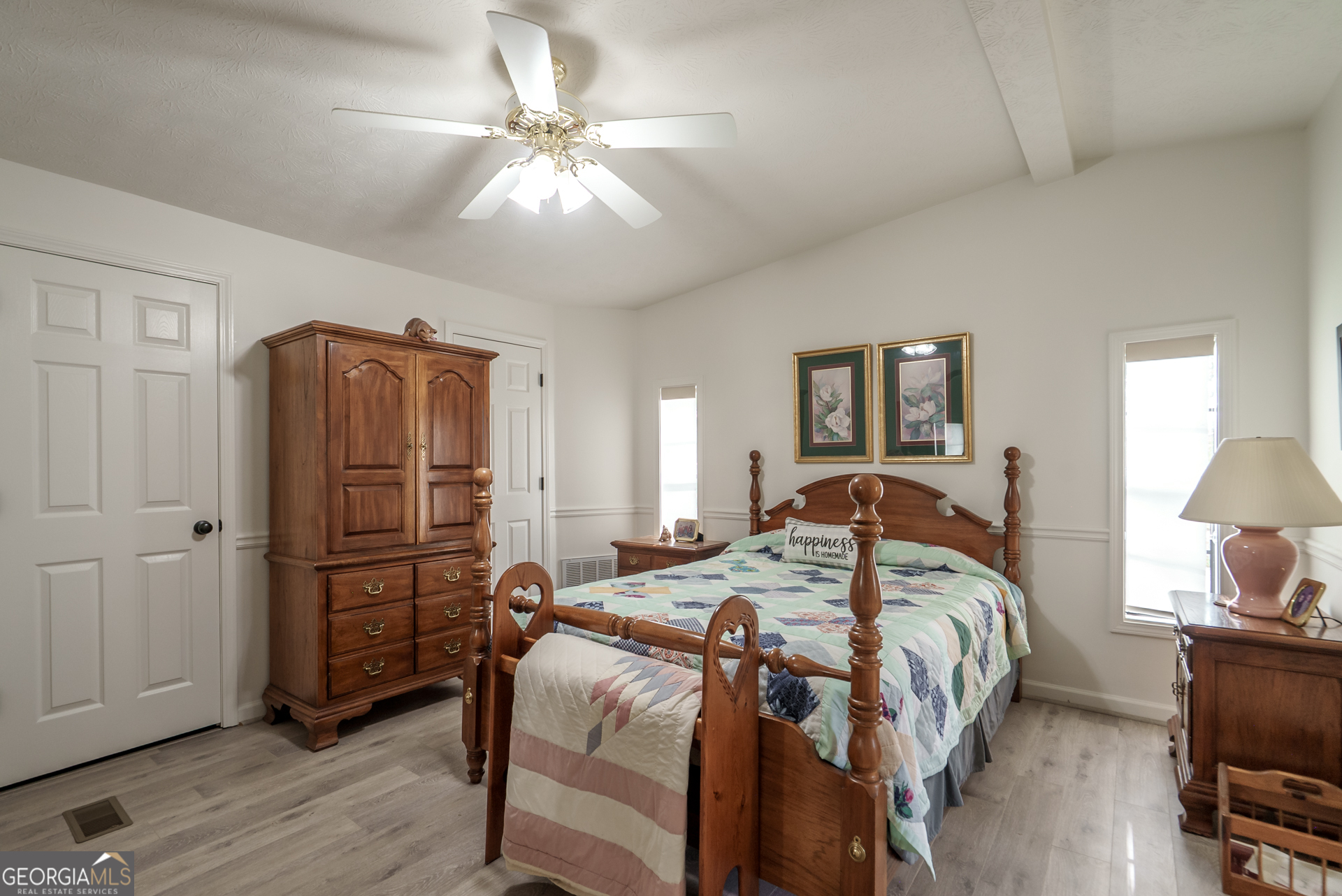 1180 Greenbriar Drive Madison, GA 30650 - Photo 21 of 54 a bedroom with a bed and a chandelier