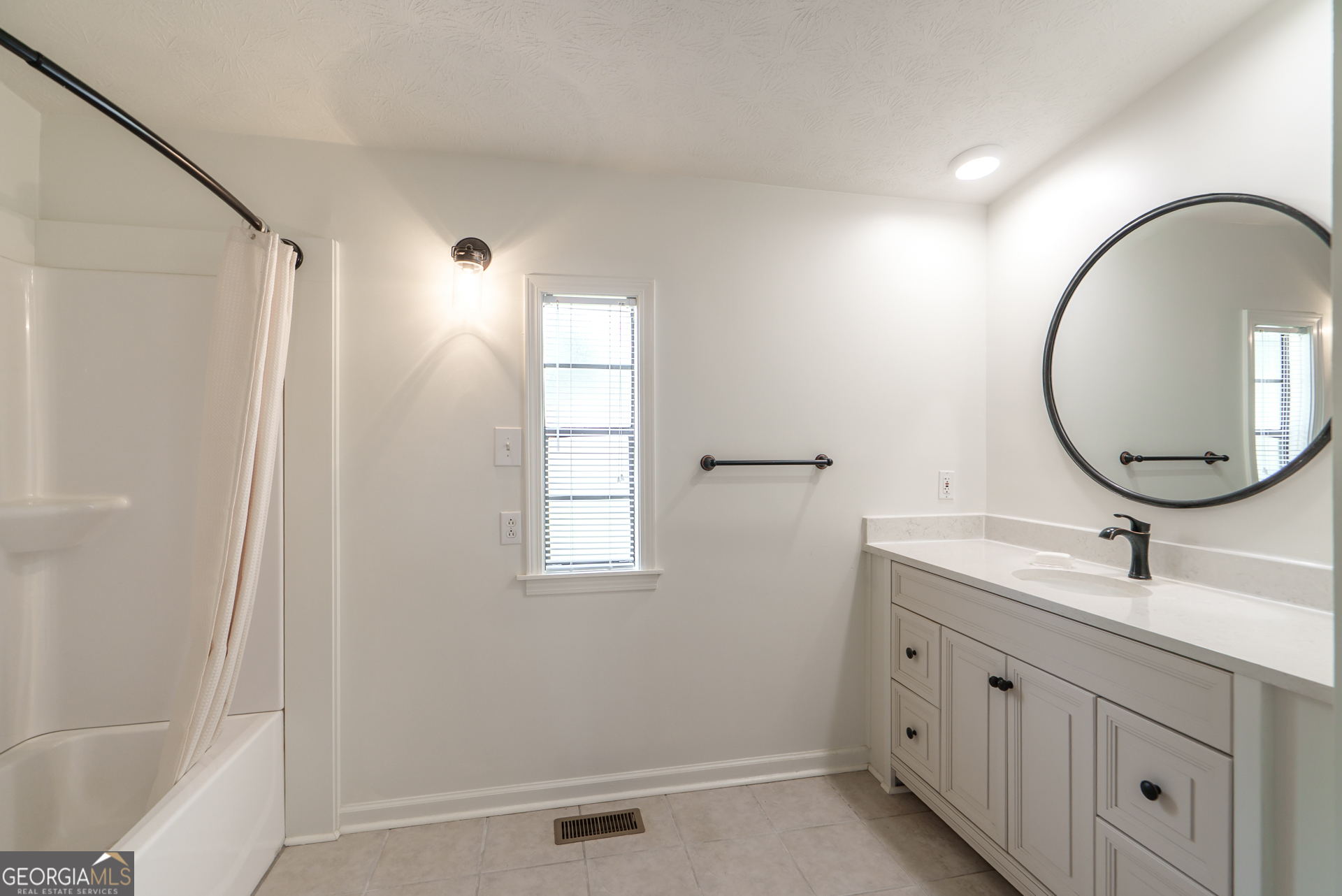 1180 Greenbriar Drive Madison, GA 30650 - Photo 23 of 54 a bathroom with a double vanity sink and a mirror