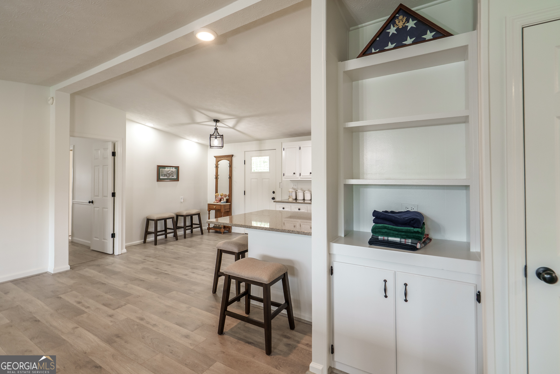 1180 Greenbriar Drive Madison, GA 30650 - Photo 26 of 54 a kitchen with white cabinets and chairs