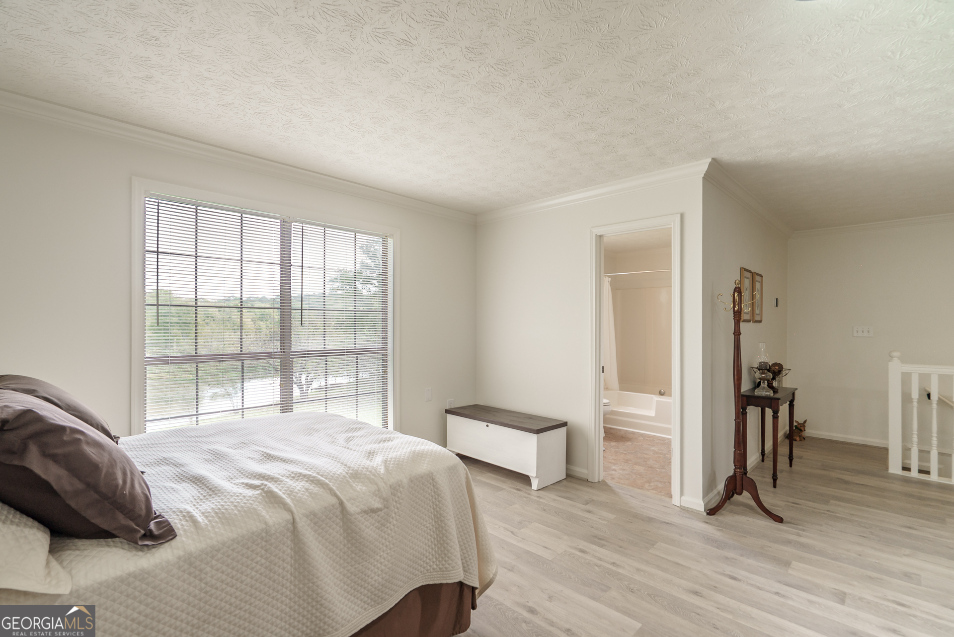 1180 Greenbriar Drive Madison, GA 30650 - Photo 35 of 54 a bedroom with a bed and a large window