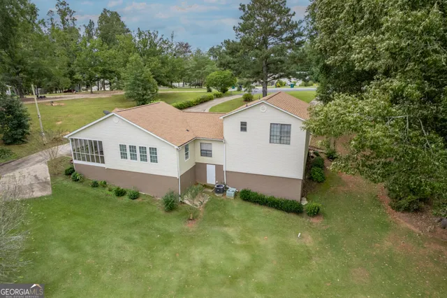 a view of a house with a yard and sitting area