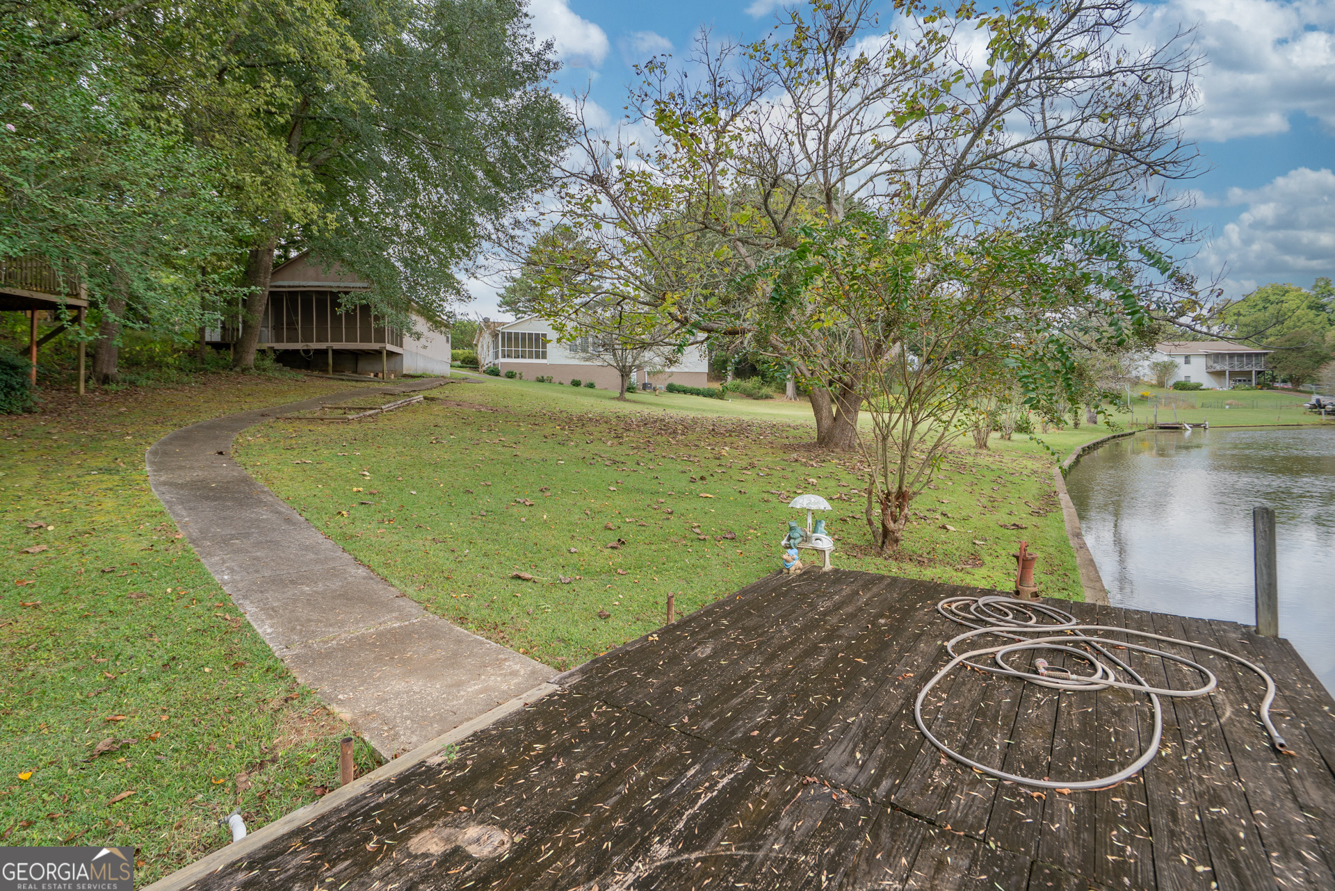 1180 Greenbriar Drive Madison, GA 30650 - Photo 44 of 54 a backyard of a house with table and chairs