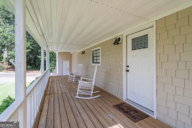 a living room with furniture a flat screen tv and a large window