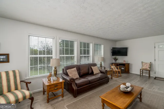 a living room with furniture and a dining table