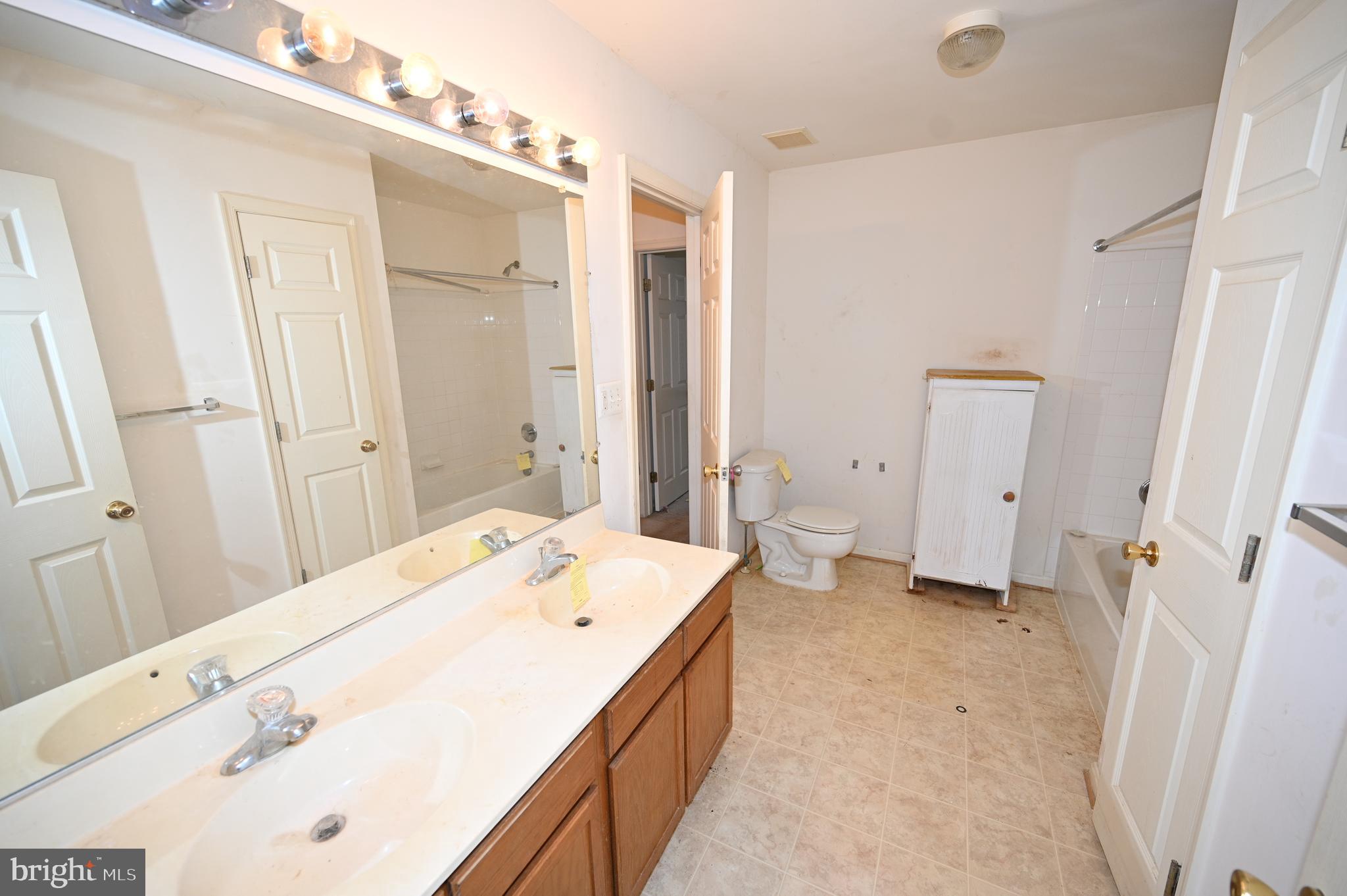 1841 Tubman Road Southeast Washington, DC 20020 - Photo 25 of 42 a spacious bathroom with a tub sink and a mirror