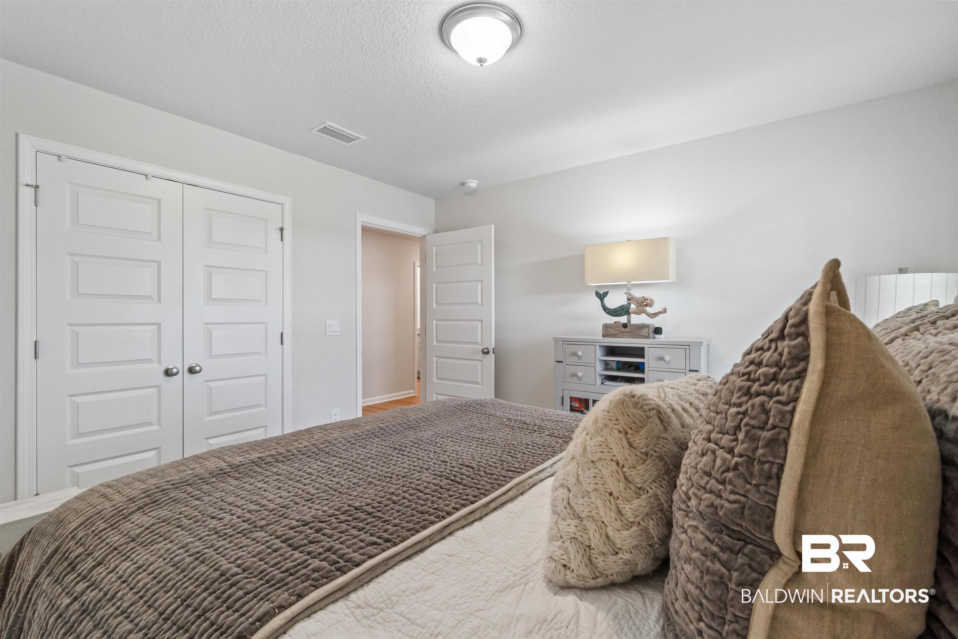 24390 Ringneck Loop Elberta, AL 36530 - Photo 34 of 39 Bedroom with a textured ceiling and a closet