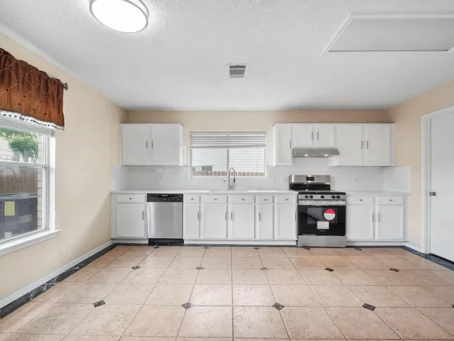 an empty room with wooden floor and closet