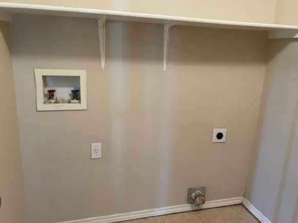 a view of an empty room with ceiling fan and wooden floor