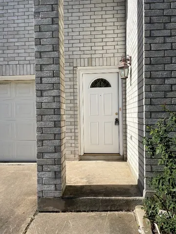a view of an empty room with a fireplace and a window