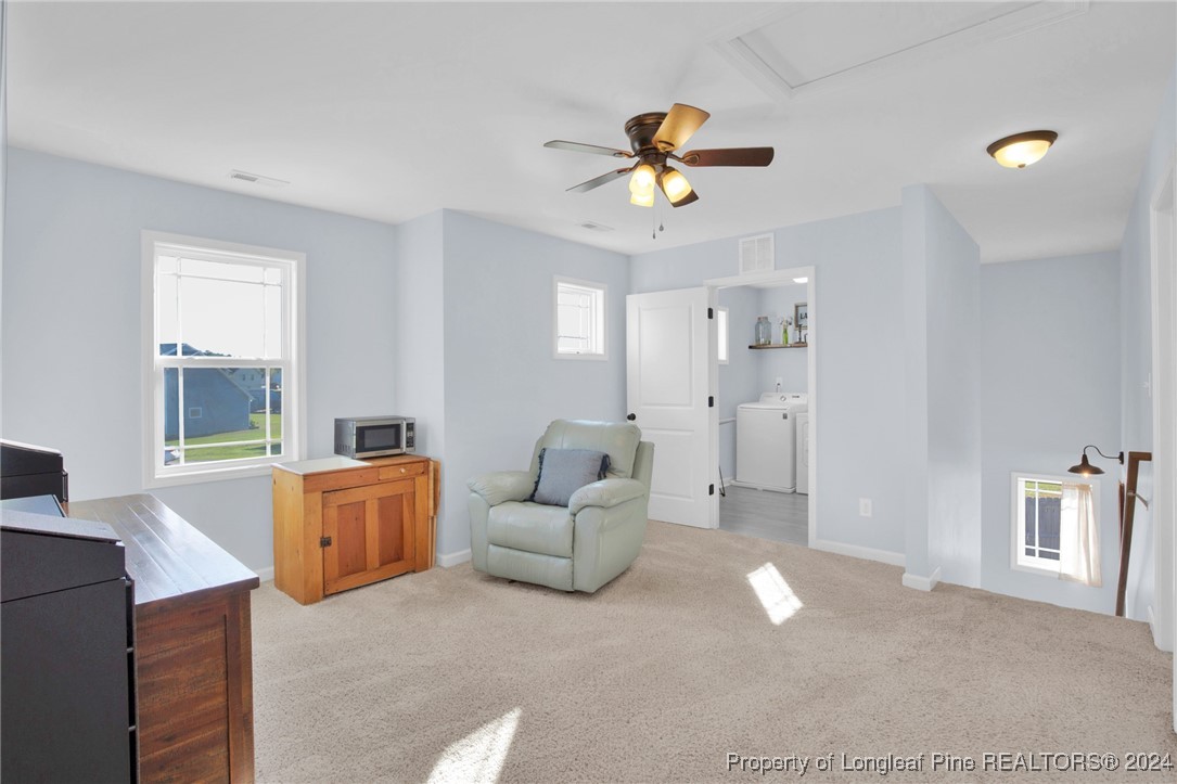 11 Rainmaker Street Linden, NC 28356 - Photo 11 of 32 a living room with furniture and a chandelier