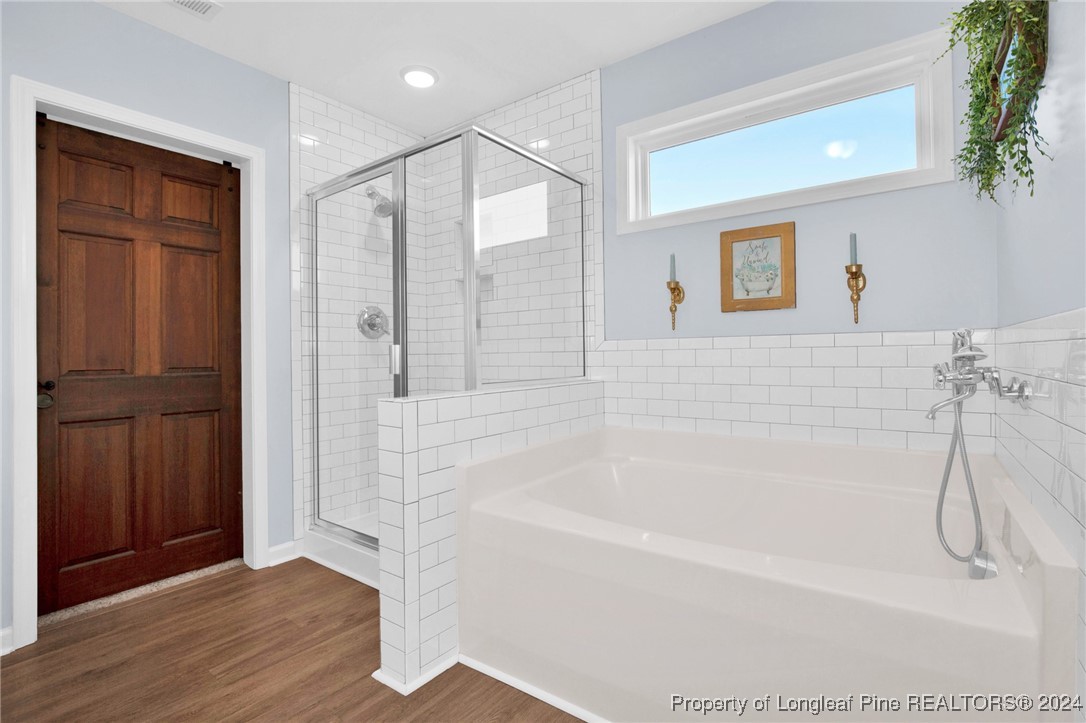 11 Rainmaker Street Linden, NC 28356 - Photo 16 of 32 a bathroom with a bathtub and a shower
