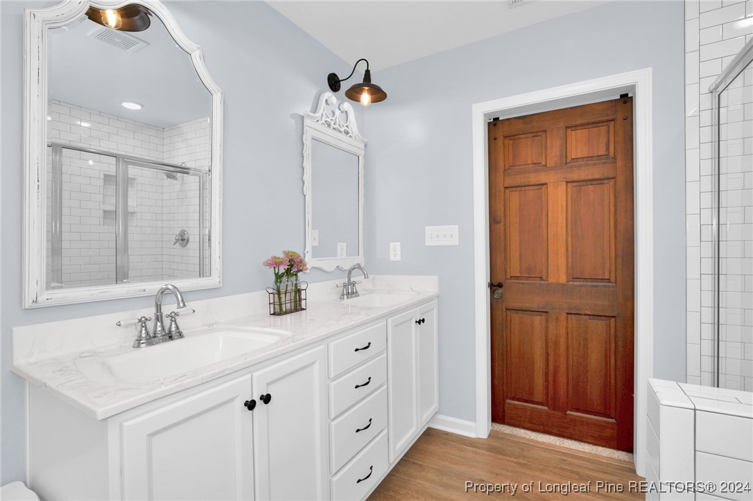 11 Rainmaker Street Linden, NC 28356 - Photo 17 of 32 a bathroom with a double vanity sink and a mirror