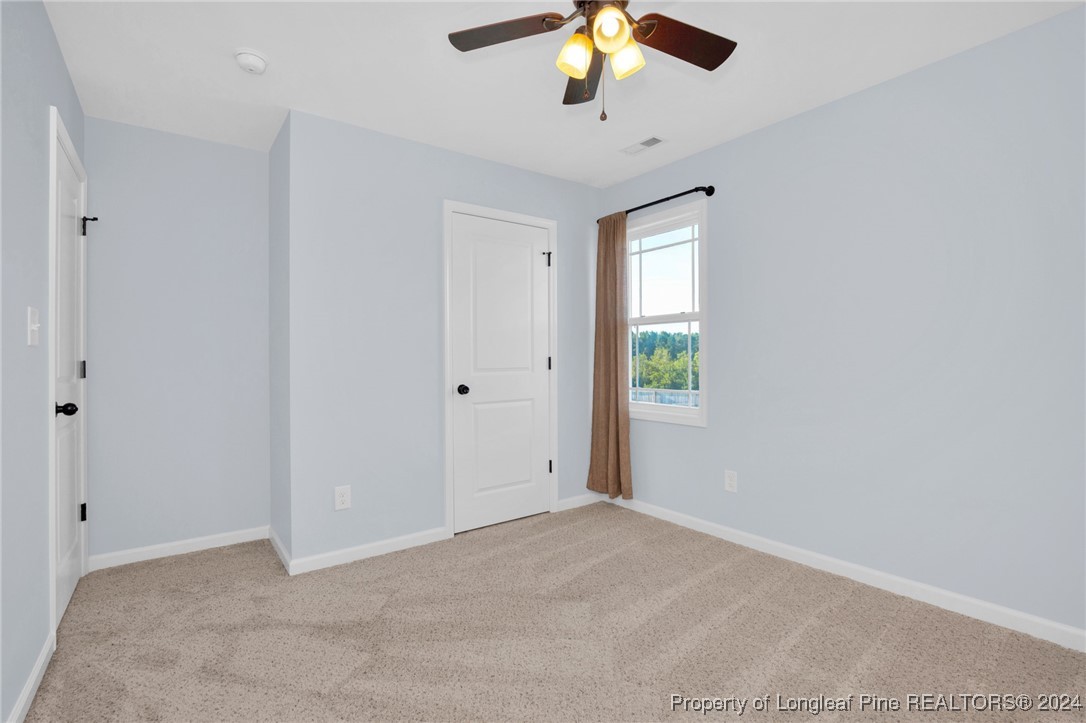 11 Rainmaker Street Linden, NC 28356 - Photo 20 of 32 an empty room with a window and a chandelier fan