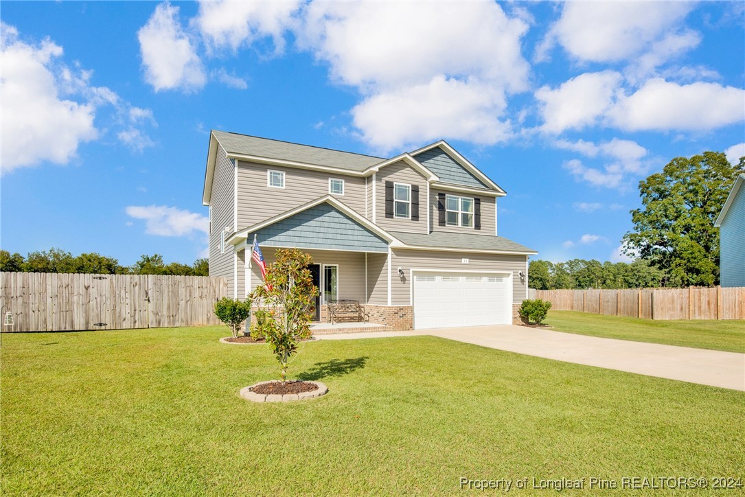 11 Rainmaker Street Linden, NC 28356 - Photo 2 of 32 a front view of a house with a yard table and chairs