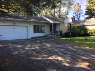 920 North Happ Road Northfield, IL 60093 - Photo 1 of 3 a front view of a house with a yard and garage