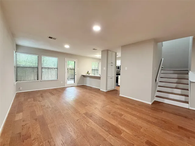 a view of kitchen with refrigerator stove and cabinets