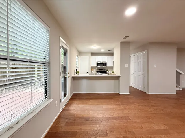 a kitchen with appliances a sink and cabinets