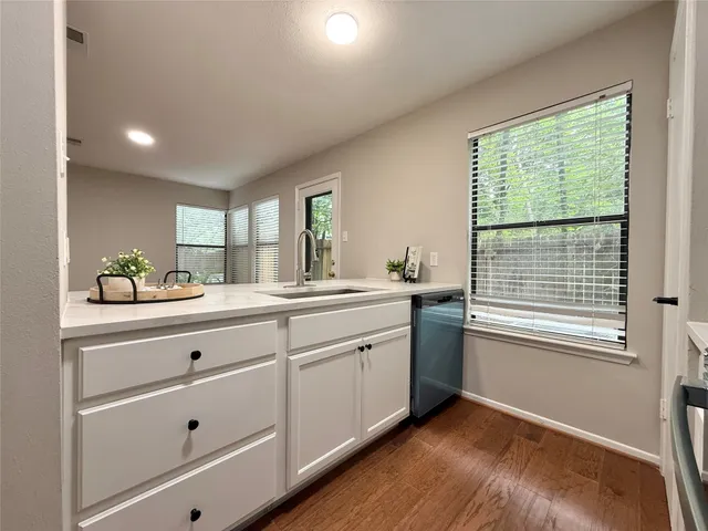 a spacious bathroom with double vanity and a window