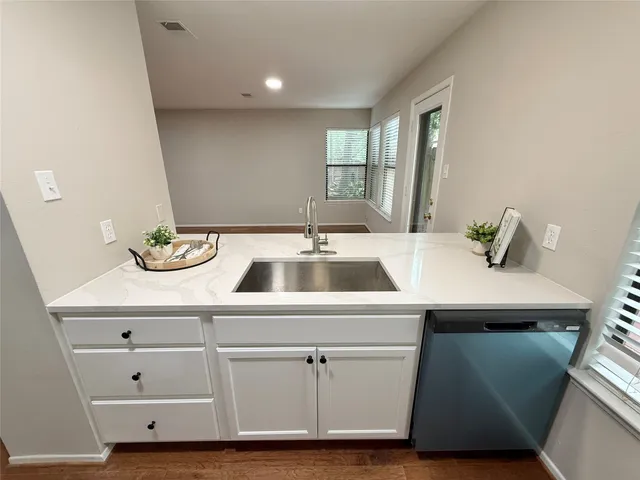 a kitchen with a sink and cabinets