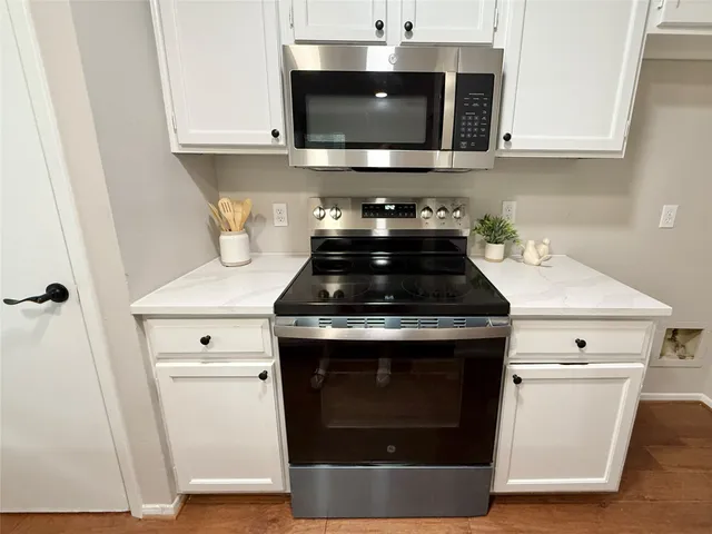 a kitchen with a stove and a microwave