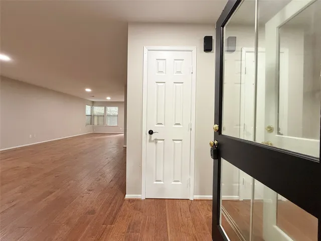 a view of hallway with wooden floor