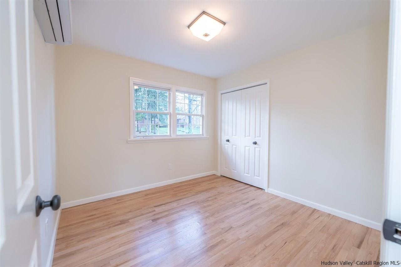 20 Robin Lane Kingston, NY 12401 - Photo 24 of 35 an empty room with wooden floor and windows