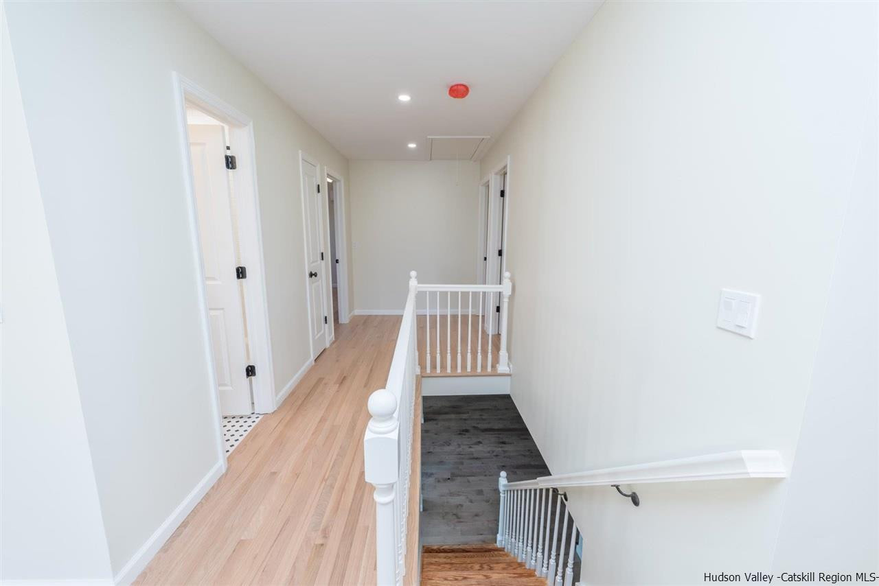 20 Robin Lane Kingston, NY 12401 - Photo 26 of 35 a view of a hallway with wooden floor and staircase