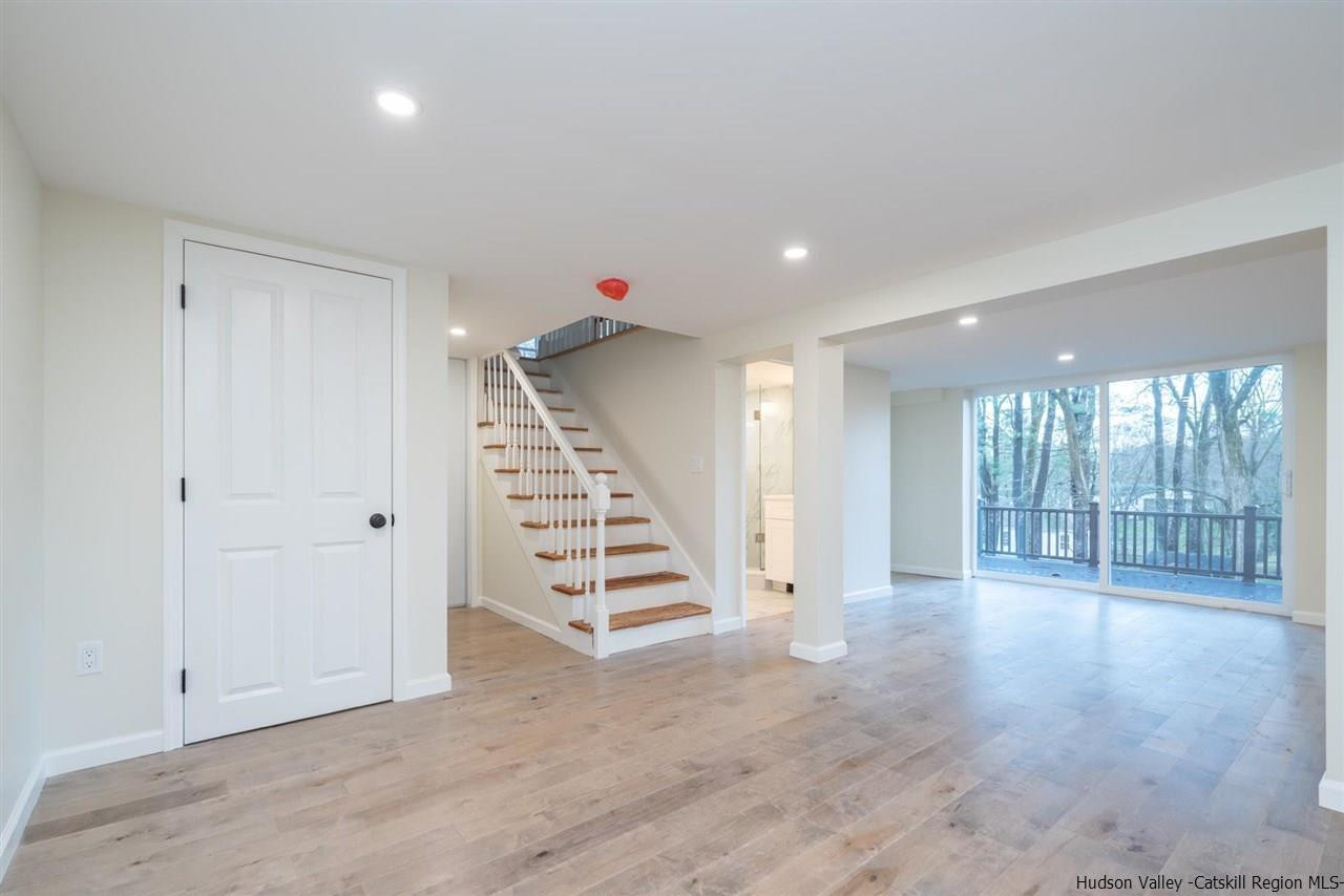 20 Robin Lane Kingston, NY 12401 - Photo 27 of 35 a view of an empty room with wooden floor and windows