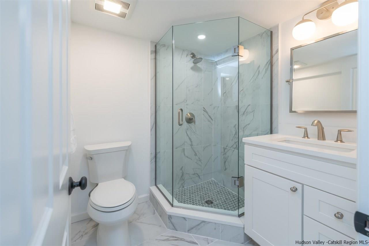 20 Robin Lane Kingston, NY 12401 - Photo 30 of 35 a bathroom with a shower sink vanity mirror and toilet