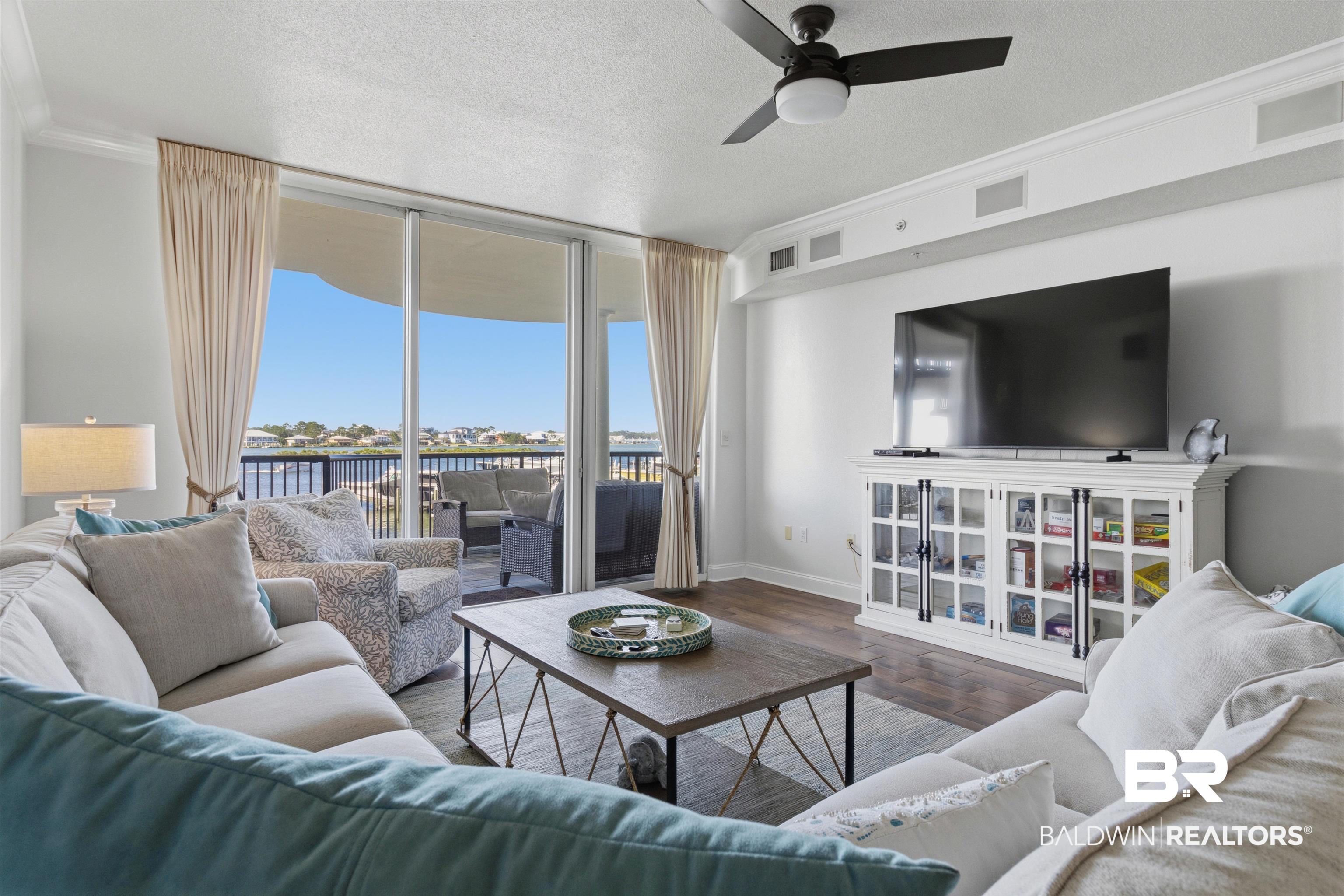 3564 Bayou Road, Unit 203 Orange Beach, AL 36561 - Photo 16 of 53 Living area featuring expansive glass sliding doors opening to a private balcony